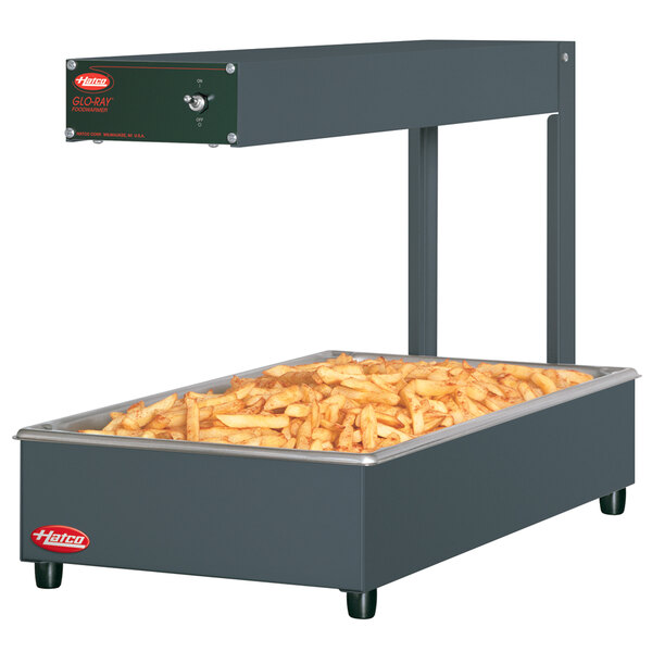 A large rectangular Hatco food warmer with french fries inside.