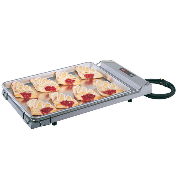 A Hatco food warmer with a tray of pastries on it.