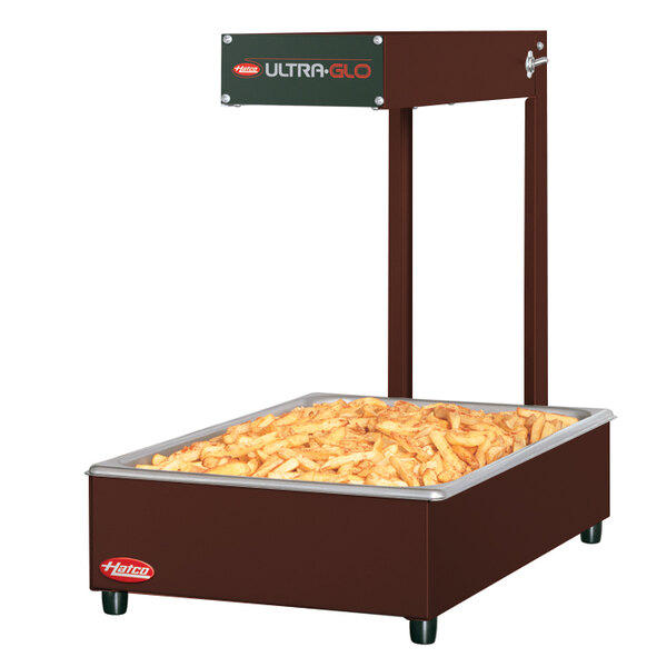 A Hatco Ultra-Glo copper portable food warmer with french fries in it.