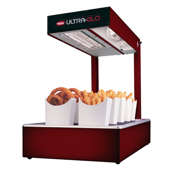 A food cart with a Hatco Ultra-Glo food warmer holding a variety of fries.
