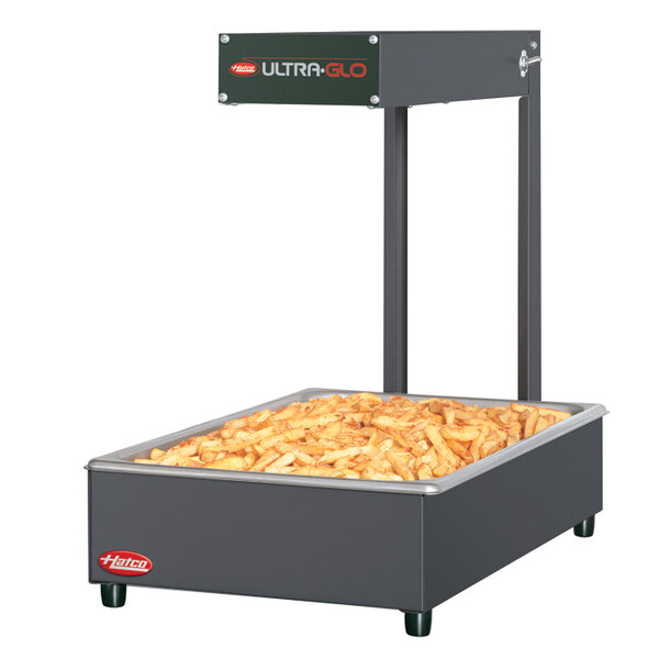 A Hatco Ultra-Glo food warmer with french fries in a large rectangular container.