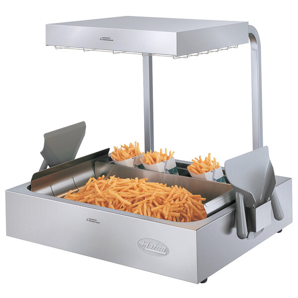 French fries in a Hatco fry holding station on a metal counter.