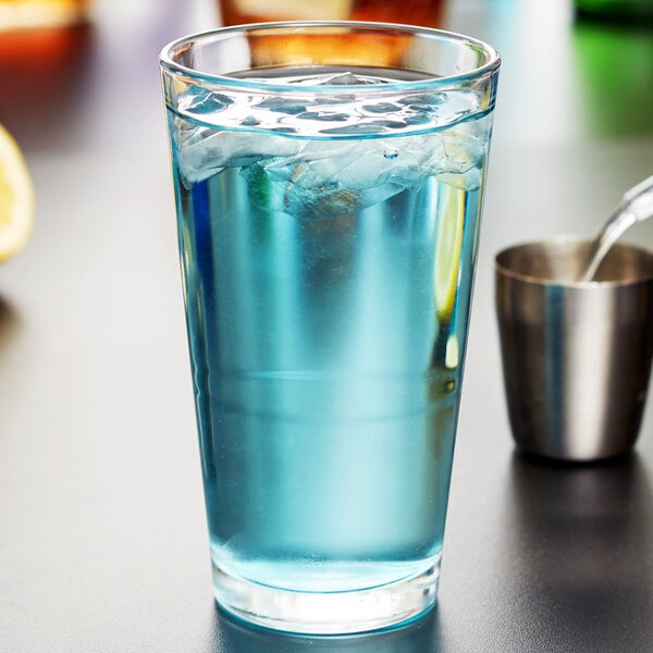 A Libbey stackable mixing glass with a blue drink and ice.