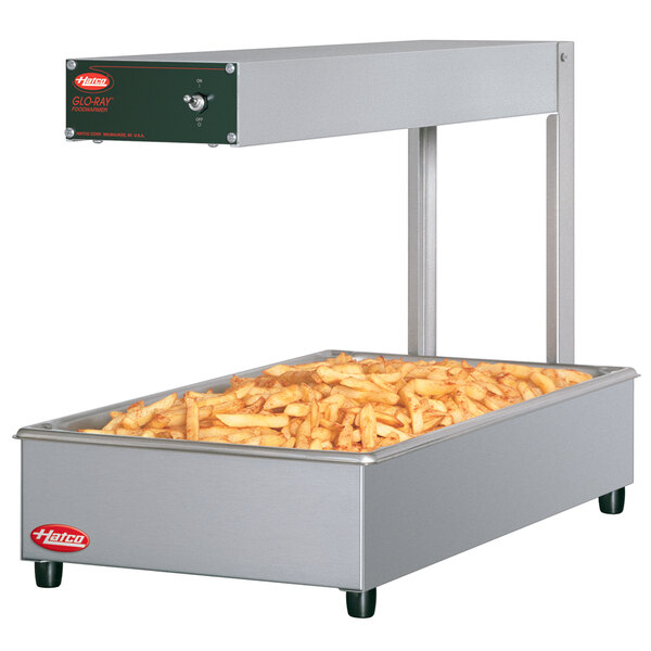 A Hatco portable food warmer with french fries on top.