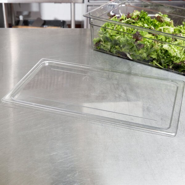 A plastic container with a lid on a plastic tray with a salad container.