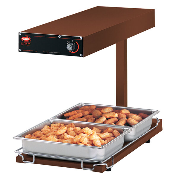 A Hatco food warmer with tater tots on trays.