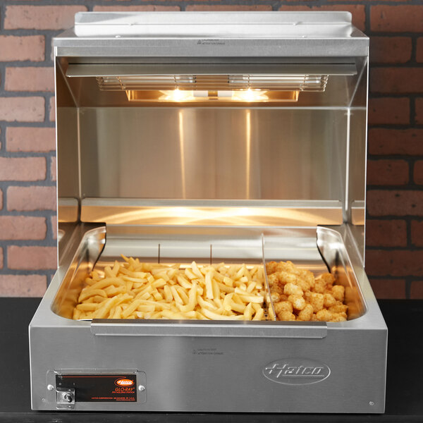 A Hatco fry dump station with fries in it.