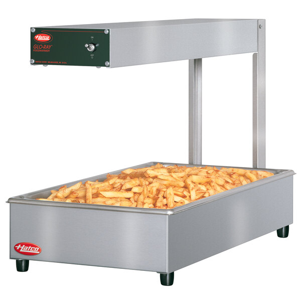 A Hatco portable food warmer on a counter with french fries inside.