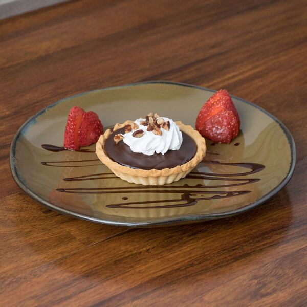 A TuxTrendz Artisan Mojave china plate with a chocolate tart, whipped cream, and strawberries on a wood table.