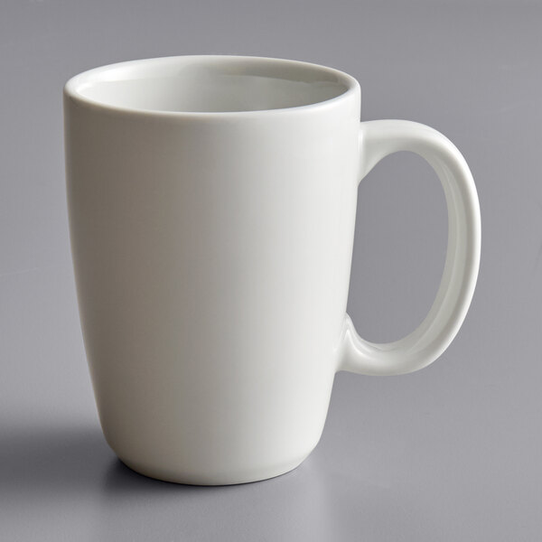 A Tuxton porcelain white mug with a handle.