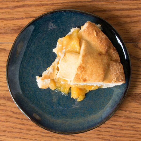 A piece of pie on a Tuxton Artisan Night Sky china plate.