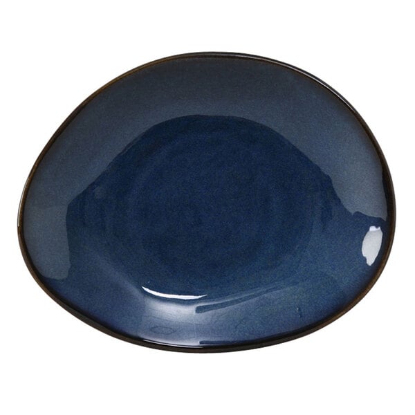 A blue ellipse plate with a black rim and white spots.