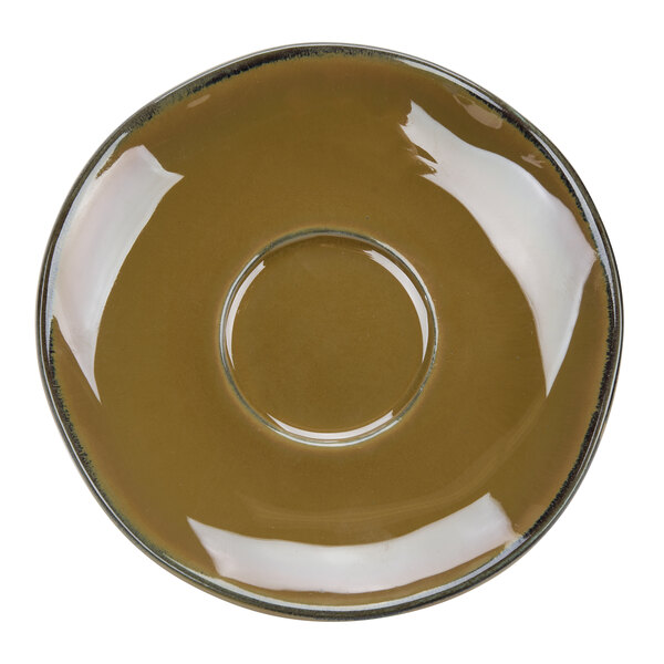A brown saucer with a white circle in the middle.
