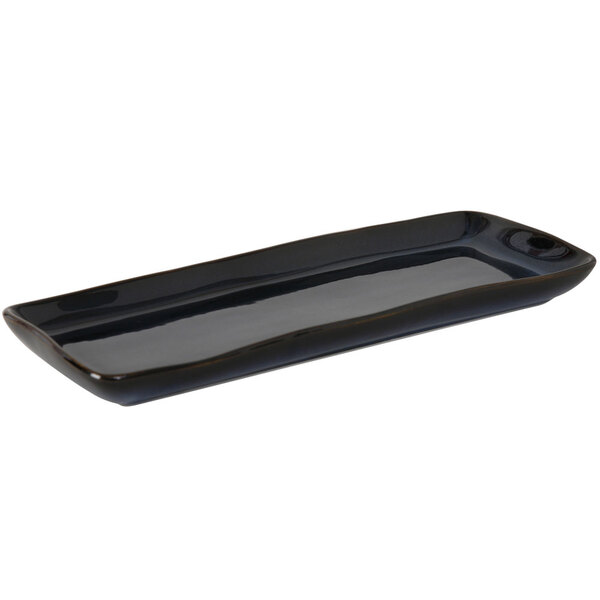 A black rectangular Tuxton china tray with a long handle.