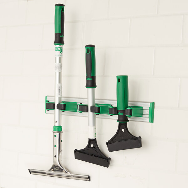 A Unger Griddle Cleaning Set hanging on a wall.