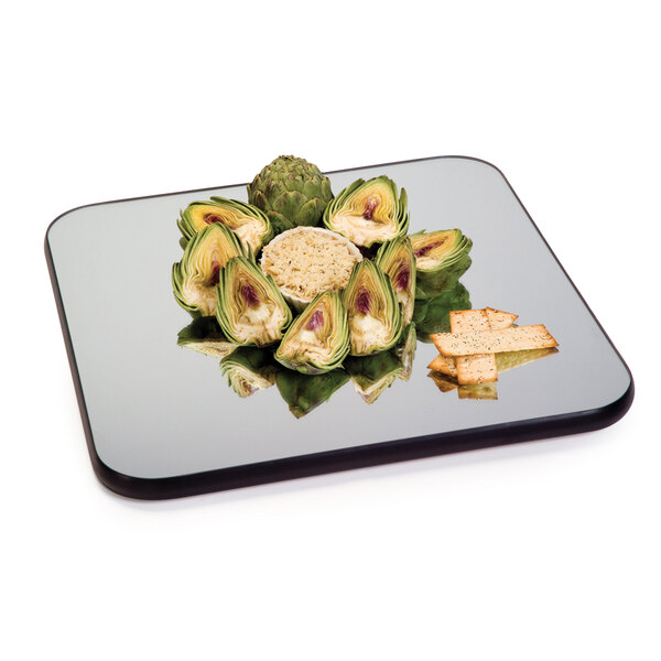A Geneva rimless square mirror food display tray with artichokes and crackers on it.