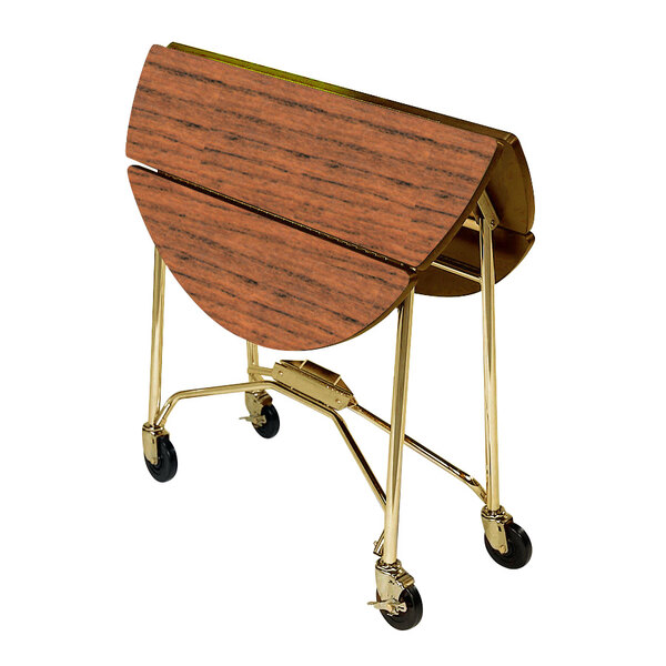 A Lakeside room service table with a Victorian cherry finish and gold wheels on a cart.