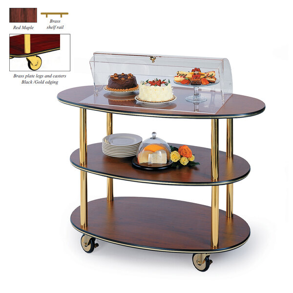 A Geneva 3 tier serving cart with food on it, including a cake.