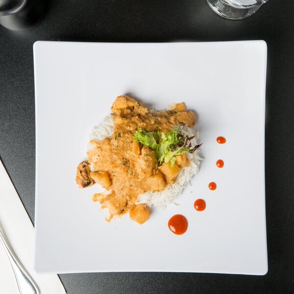 A white Thunder Group square melamine plate with chicken curry, rice, and sauce.