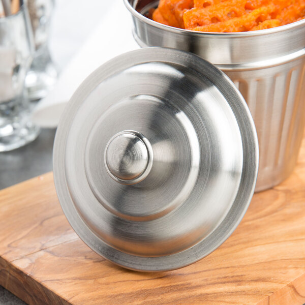 An American Metalcraft mini stainless steel trash can lid on a metal container with food in it.