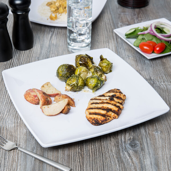 A Thunder Group Classic White square melamine plate with food on it and a silver utensil.