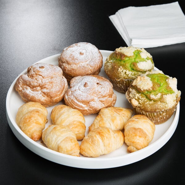 A white American Metalcraft porcelain serving plate with pastries and muffins.