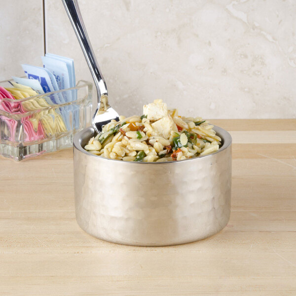 An American Metalcraft stainless steel bowl filled with food and a spoon.