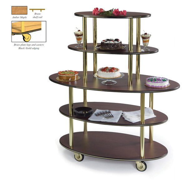 A Geneva oval serving cart with three wooden shelves with cakes on them.