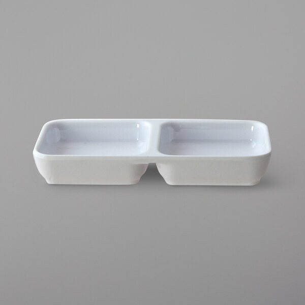 Two white rectangular Thunder Group sauce dishes with two compartments.