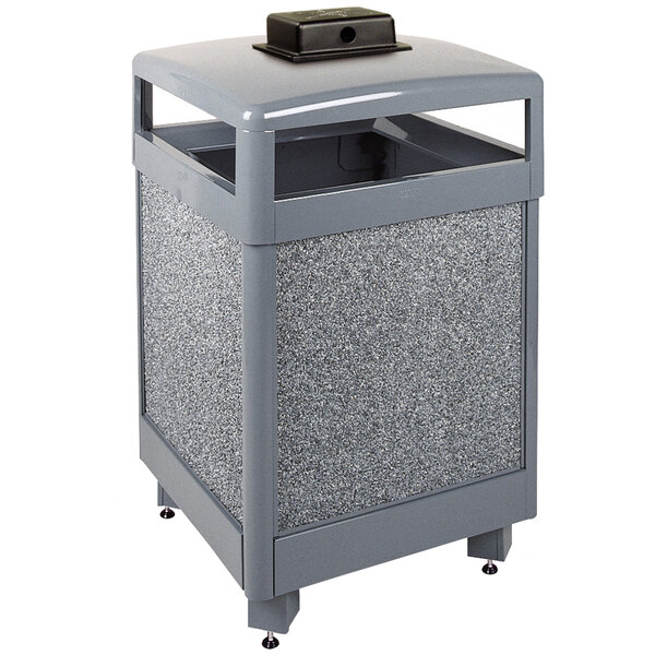 A grey Rubbermaid square steel waste receptacle with a hinged lid and weather urn.