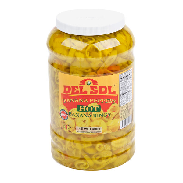 A case of Del Sol banana pepper jars with white lids on a counter.