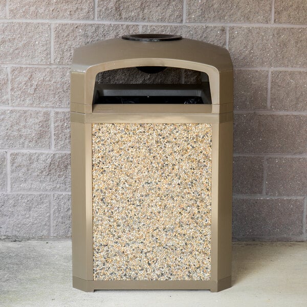 A brown Rubbermaid Landmark Series Classic trash can with a River Rock aggregate panel.