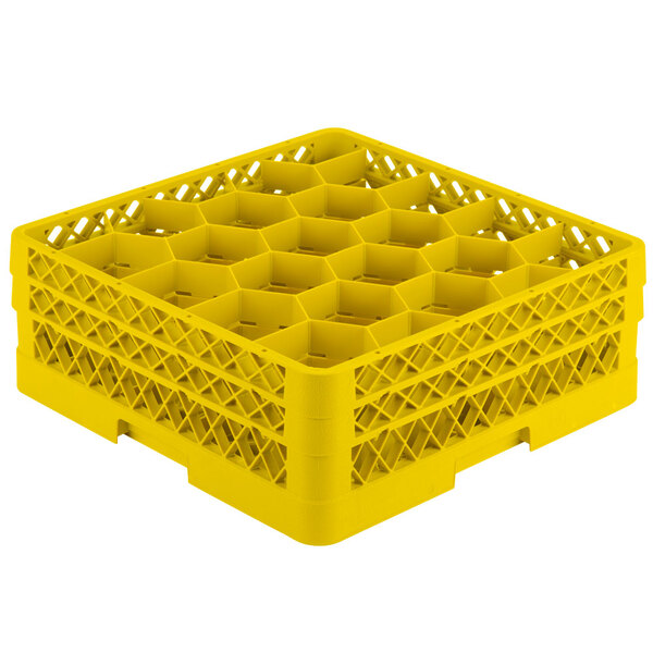 A yellow plastic Vollrath glass rack with 20 compartments.