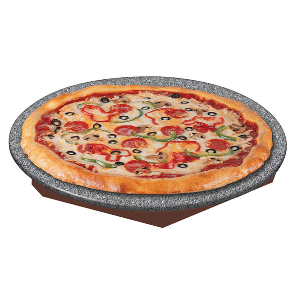 A pizza with pepperoni and olives on a Hatco heated stone shelf.