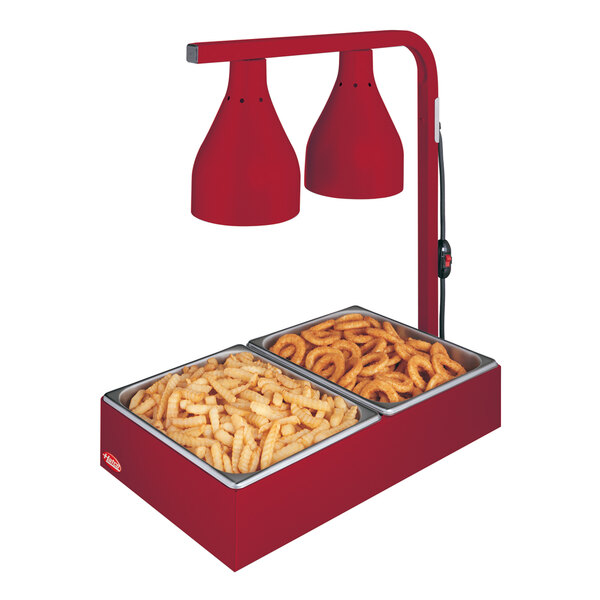 A red Hatco countertop bulb warmer with two trays of food inside.