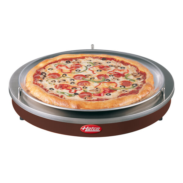 An Hatco drop in heated shelf with a pizza on a plate.