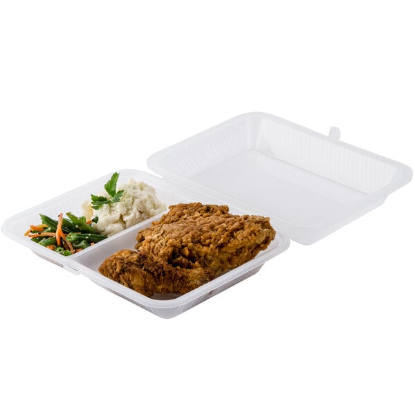 A clear GET 2-compartment reusable container with fried chicken and vegetables.