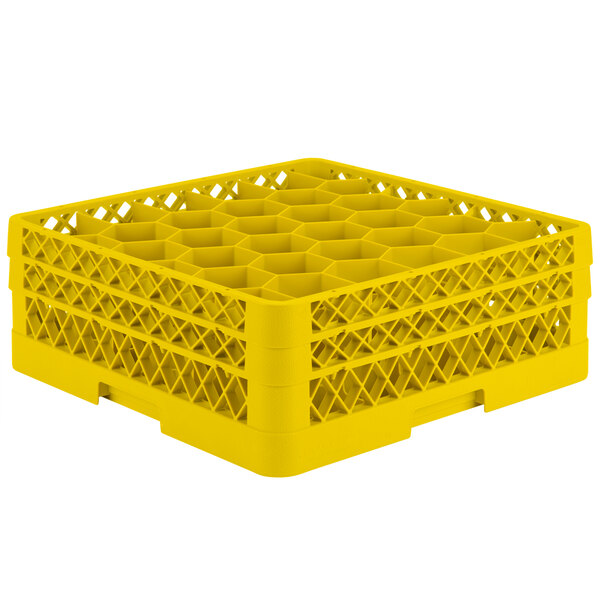 A yellow plastic Vollrath Traex glass rack with 30 compartments.