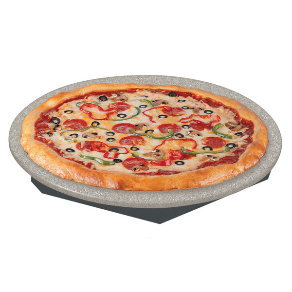 A pizza on a Hatco heated stone shelf in a pizza parlor.