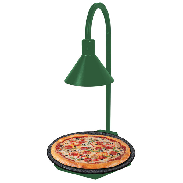 A Hatco heated stone shelf with a green lamp warming a pizza.