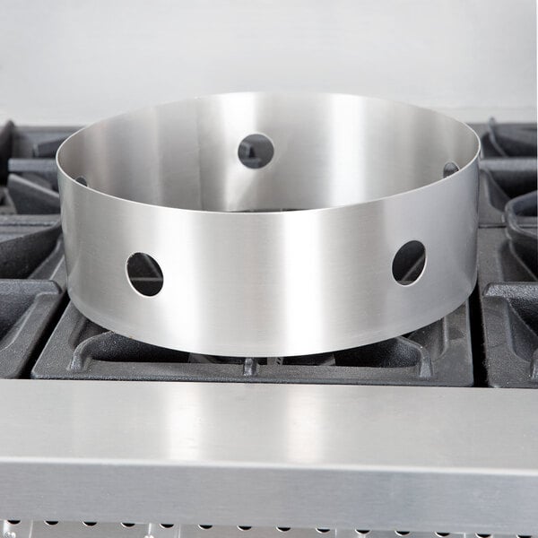 A Town stainless steel circular wok ring with holes.