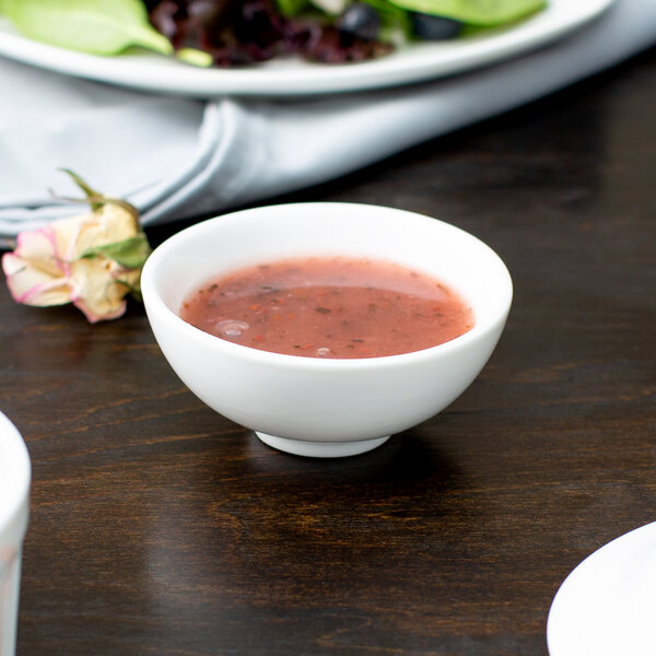 A bowl of red sauce in a 10 Strawberry Street white porcelain sauce dish.