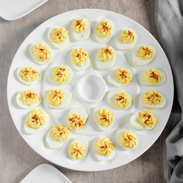A white 10 Strawberry Street porcelain egg platter holding deviled eggs.