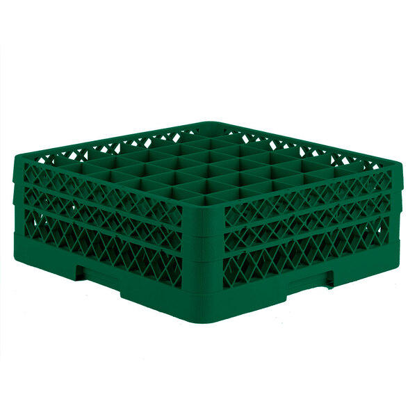 A green plastic Vollrath Traex glass rack with many compartments.