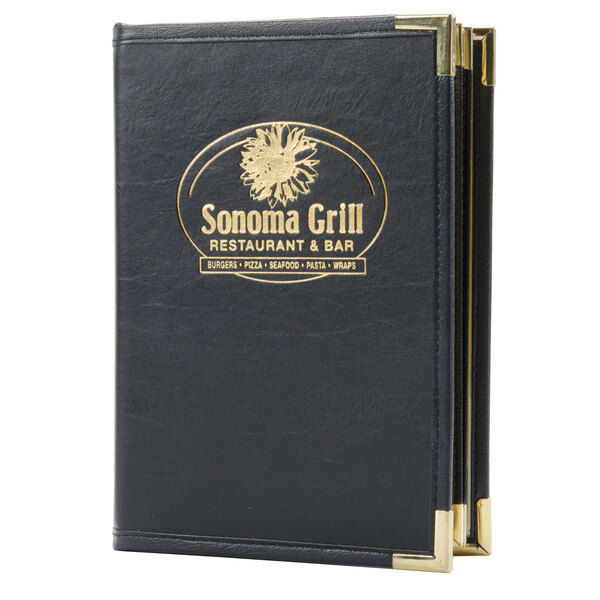 A black leather Menu Solutions Royal Select series menu cover with a custom logo on a table.