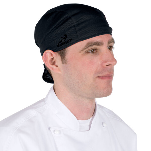 A man wearing a black Headsweats shorty chef cap.
