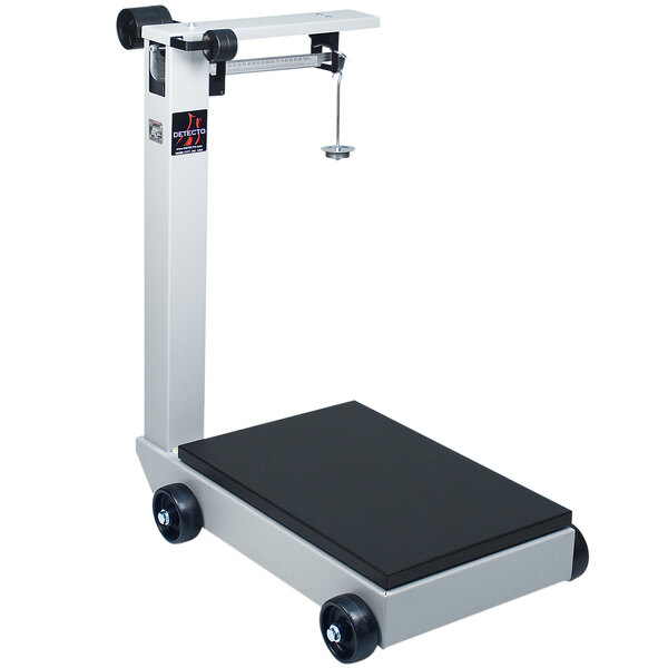 A Cardinal Detecto portable mechanical floor scale with wheels.