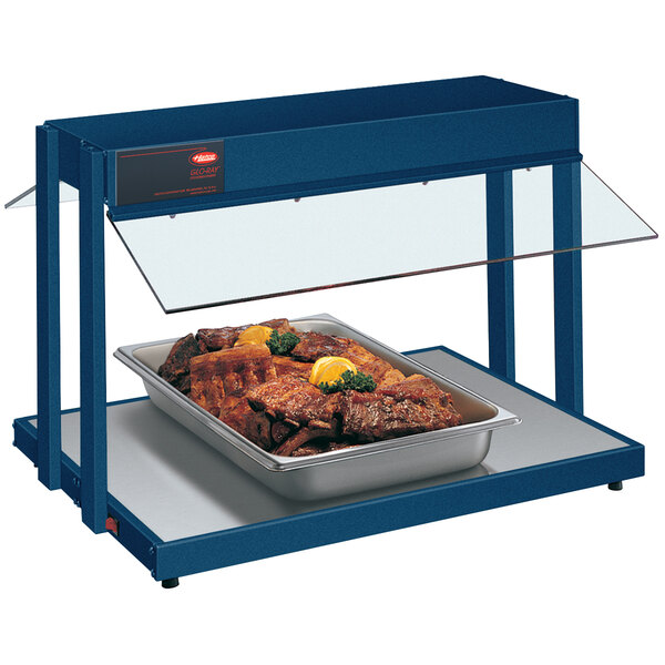 A navy blue Hatco countertop buffet warmer with a tray of meat on it.