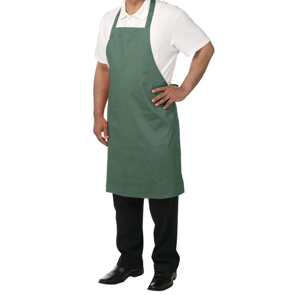 A man wearing a Chef Revival hunter green bib apron.