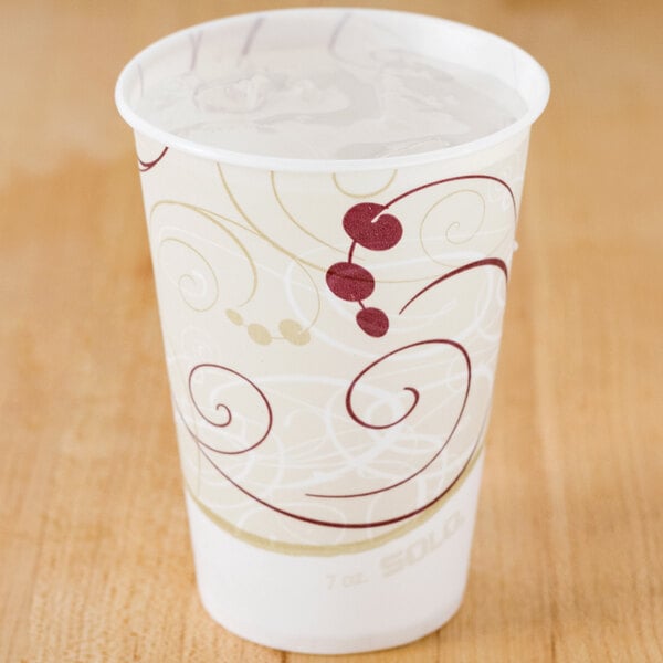 A Solo wax treated paper cold cup with a swirl design on it.